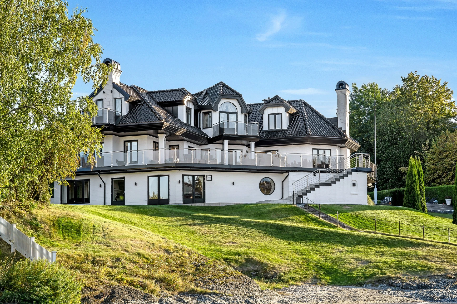 Daytime exterior view of luxury house with landscaping