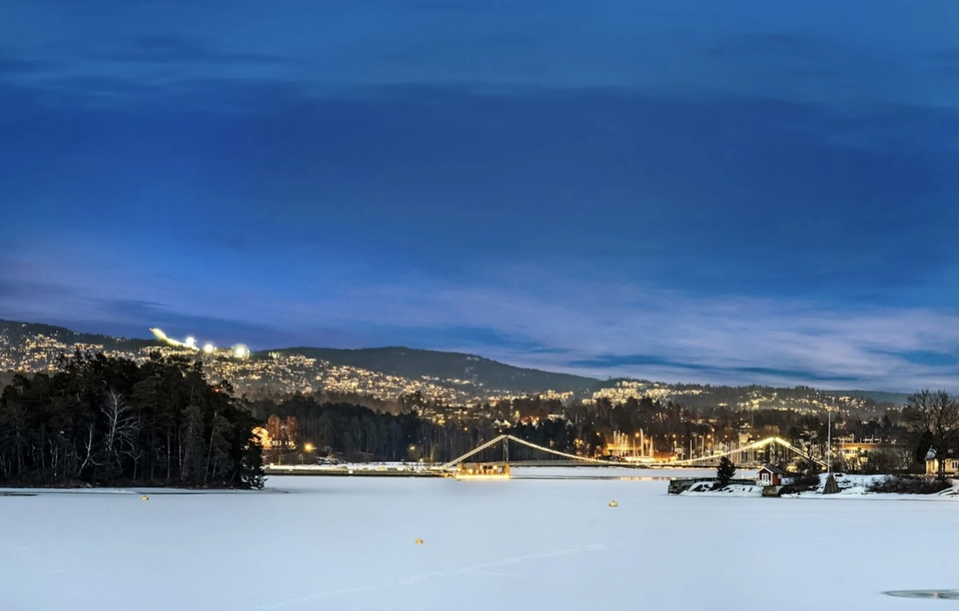 Panoramic winter view of Oslo fjord with city lights