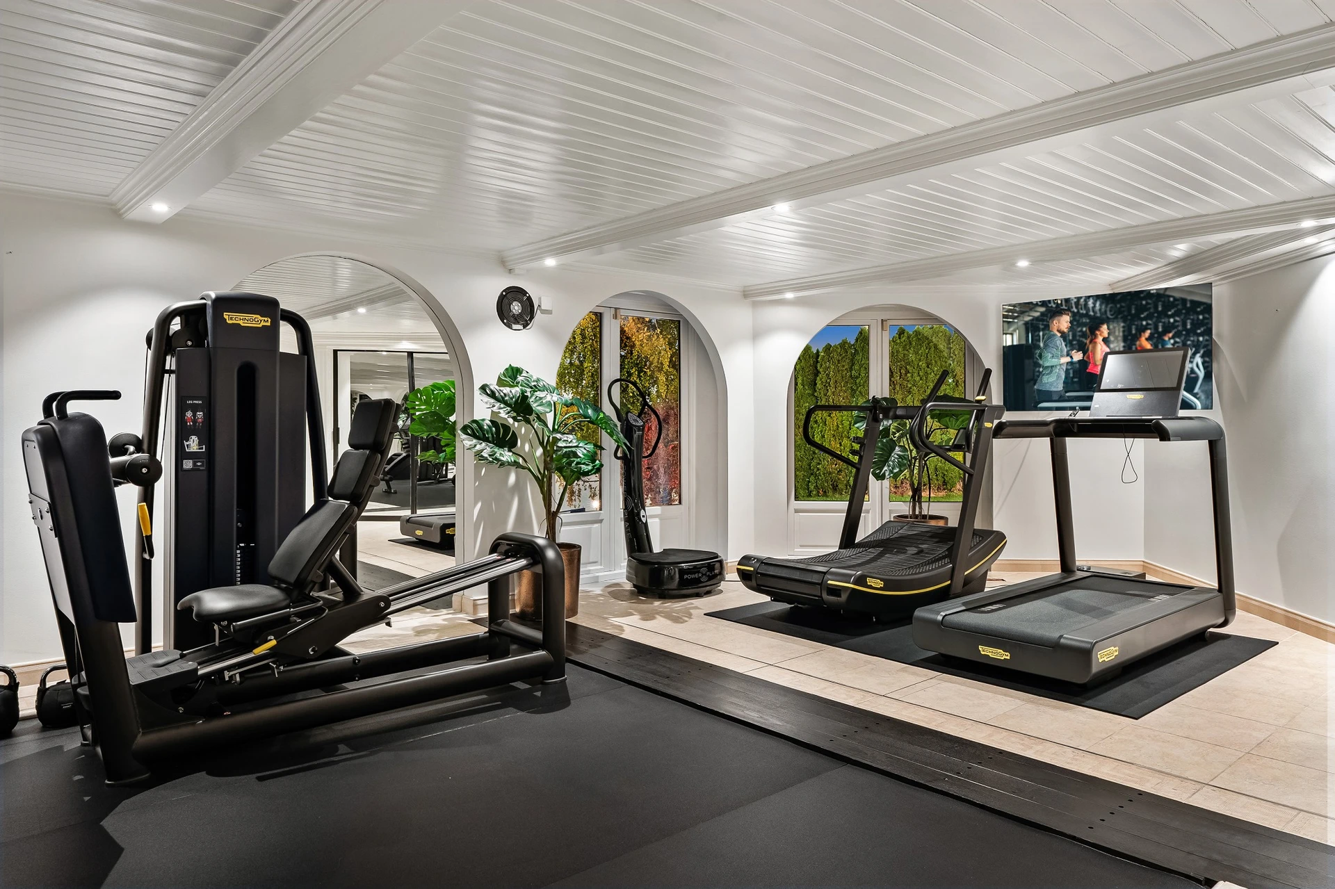 Specialized gym equipment with arched architecture and garden views